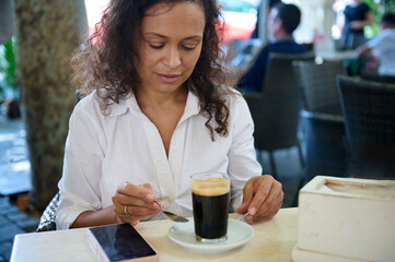 Woman enjoying a relaxing coffee break at outdoor cafe