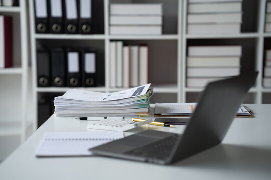 Organized Workspace: Productivity and efficiency at its peak. A sleek laptop rests on a pristine desk, surrounded by neatly organized paperwork, notebooks, and office supplies.