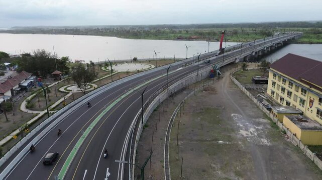 An aerial view of the stunning Kretek II bridge and the large river that flows into Parangtritis beach, Yogyakarta.