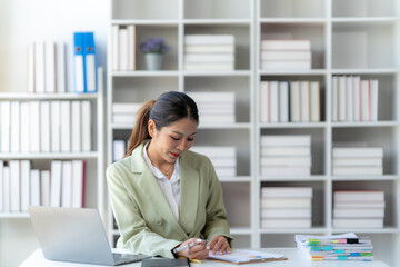 Focused and Determined: A businesswoman, dressed in professional attire, meticulously takes notes...