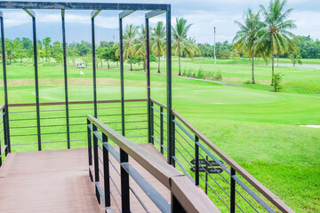 Fototapeta premium Panorama view of Golf Course where the turf is beautiful and green, Golf cart,Golf cart in fairway of golf course,Golf course with a rich green turf beautiful scenery,sport club,copy space.