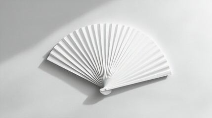 A simple white folding hand fan laid flat on a clean white surface, ideal for branding and mockup designs.