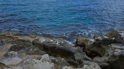 Rocky coastline with clear blue waters in torre dell'orso, salento, puglia, italy, europe, showcasing the natural beauty of the mediterranean sea and rugged shoreline.