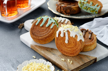 Round croissants with different  filling and glaze, trendy dessert.