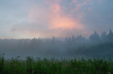 A misty summer sunset in the Southern Urals.