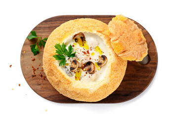 Cream soup with chicken and mushrooms, beautifully served in a bun. isolated on white background, top view