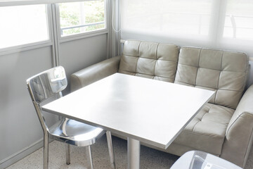 Aluminum chair and gray sofa in restaurant,Contemporary interior design of light spacious dinning room,modern furniture in living room or office,copy space.