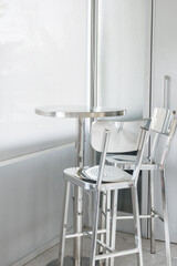 Aluminum chair and table in restaurant,Contemporary interior design of light spacious dinning room,modern furniture in living room or office,copy space.