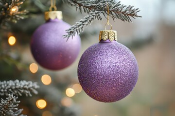 Decorative purple Christmas ornament hanging from a tree branch with soft glowing lights in the background, adding festive charm.