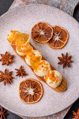 Sweet dessert eclairs or profiteroles with chocolate filling