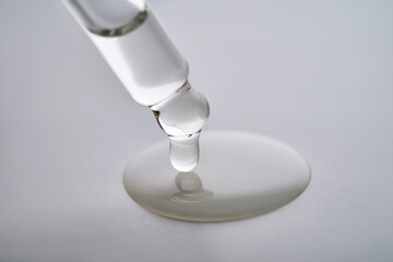 Dropper pipette with delicious serum with drop close-up.