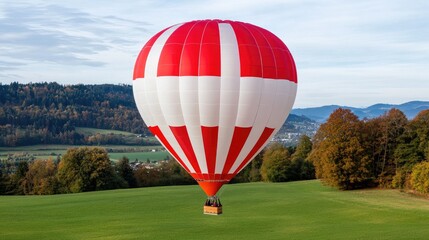 Obraz premium Majestic red and white hot air balloon gracefully soars over the stunning Swiss Alps during a breathtaking golden hour