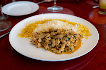 Traditional chicken stroganoff with mushrooms, straw potatoes and white rice