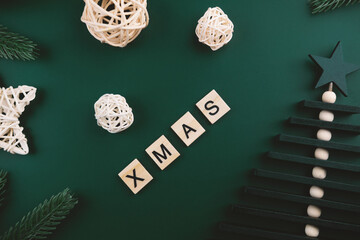 Xmas, wooden blocks on emerald background, winter banner. 