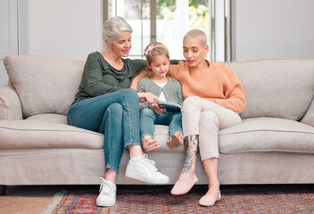 House, grandmama and girl with tablet, mother and typing with smile, happiness and relax in living room. Family, granny and daughter with tech, mom and bonding together with digital app in lounge