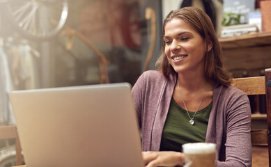 Woman, laptop and work in coffee shop of bike repair store with internet search and email. Morning, computer and small business owner with digital, cafe and website update for online company page