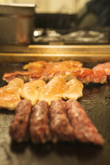 A mix of grilled meats and veggies on a plate. Excellent for restaurant menus or grillhouse promotions.