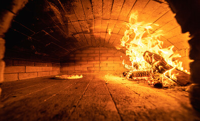 A detailed look at the interior of a traditional wood-fired oven. Ideal for branding authentic dining experiences.