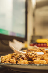 Preparation of fried squid. Perfect for culinary blogs, restaurant ads, or promoting seafood specialties.