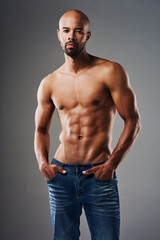 Body, fitness and portrait of shirtless black man in studio on gray background for health or wellness. Exercise, macho and masculine with athletic model in denim jeans for training or workout