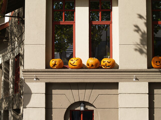 Carved Pumpkins Sitting On Ledge Of Office Building Daytime