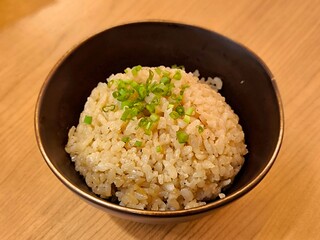 Japanese garlic fried rice in ceramic bowl on wood table. Food menu concept