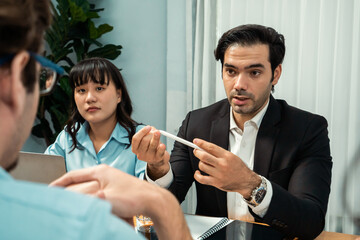 Diverse group of business analyst team analyzing financial data report paper on office table. Chart and graph dashboard by business intelligence analysis for strategic marketing planning Habiliment