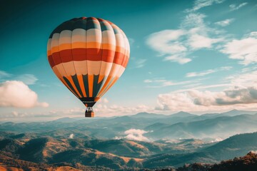Naklejka premium Colorful Hot Air Balloon Soaring Above Mountain Ranges