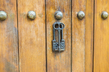Close up of old Key in wooden door at home, Brown Wood Front Door with Ornate Brass Skeleton Key,copy space..
