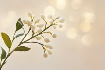 Obraz premium Delicate White Buds and Green Leaves Against a Soft, Blurry Beige Background