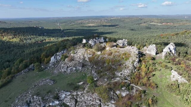 Aerial drone view of Zborow Hill, Poland. Limestone rock formation at peak of Gora Zborow, Podlesice, Poland. Krakow Czestochowa Upland. Polish Jurassic Highland Mountainl Zborow in autumn.
