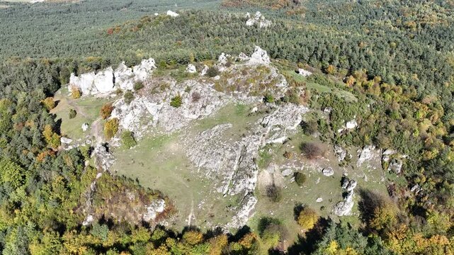 Aerial drone view of Zborow Hill, Poland. Limestone rock formation at peak of Gora Zborow, Podlesice, Poland. Krakow Czestochowa Upland. Polish Jurassic Highland Mountainl Zborow in autumn.