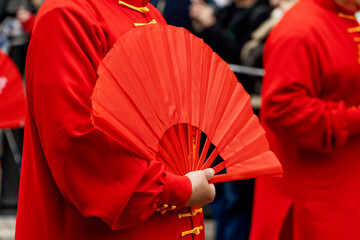 People in red outfit on a Chinese fan performance at the lunar New Year tradition in chinatown