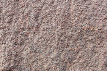 Stone. Textured red granite wall surface. Background image