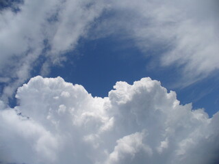 Obraz premium White and blue natural sky background with Cumulus and Cirrus clouds. Topics: weather, meteorology, atmosphere, toposphere, beauty of nature, air space, season