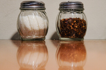 Parmesan cheese and dried chilies in the shakers.
