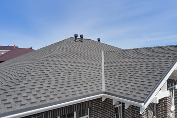 Luxury house roof with asphalt shingles