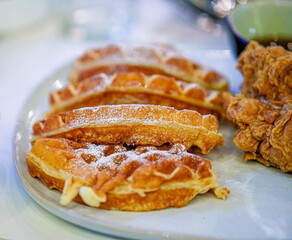 Close-up of a waffle and chicken.