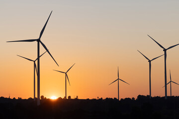 Obraz premium View of wind turbine against sunset sky