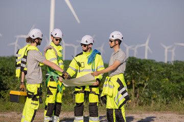 Engineers are having a discussion at wind turbine field