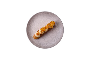 Sweet dessert eclairs or profiteroles with chocolate filling