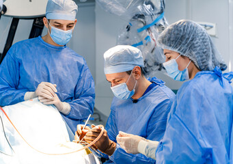 Surgical team in a complex operation. A skilled surgical team collaborates on a critical operation, demonstrating precision and teamwork in a modern medical setting.