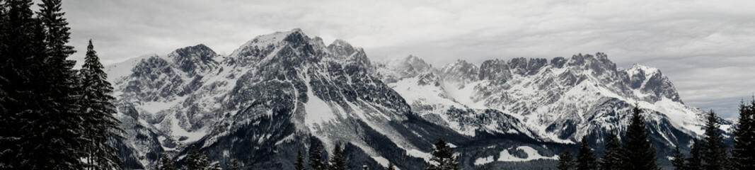 Panoram of a stunning alpine landscape with sky and beautiful forest