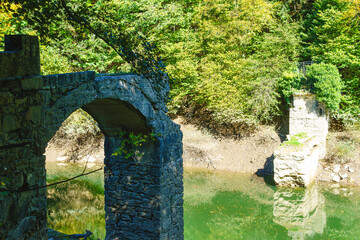 Ancient Roman stone bridge destroyed by the floods of the Irati river in the tourist Irati forest,...