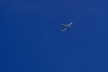 Commercial Airplane Flying in Clear Blue Sky