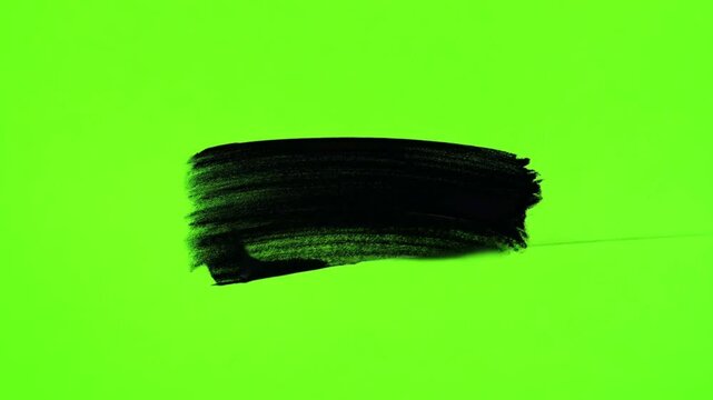 Black paint stroke on green screen background. Grunge brush texture paint background, scribble texture highlight animation in and out hand-drawn isolated green screen chroma key 4k video copy space