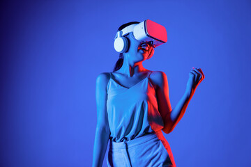 Smart female standing wearing VR headset connecting metaverse, future cyberspace community...