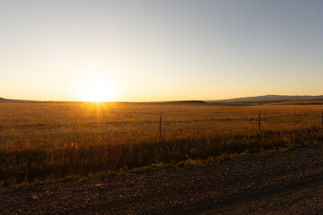 Ranch prairie sunrise, sunset over farm meadow, rural ranch landscape 