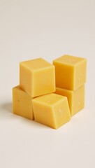 Obraz premium Cubed cheddar dairy cheese portion - concise description for block cheese with cubed yellow cheddar pieces