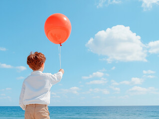 
A child is holding a balloon on a string. Air balloon on the background of the sky.